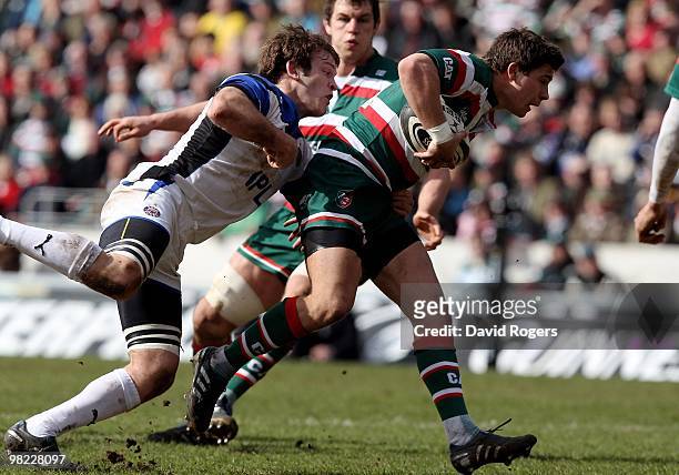 Ben Youngs of Leicester moves away from the challenge from Julian Salvi during the Guinness Premiership match between Leicester Tigers and Bath at...