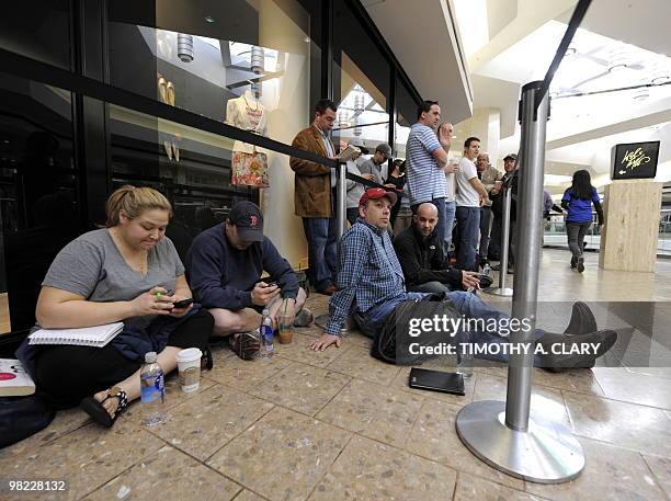 Customers wait in line to be one of the first to buy the iPad at the Apple Store at West Farms Mall in Farmington, Connecticut, on April 3, 2010....