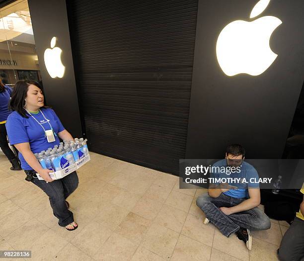 Customers wait in line to be one of the first to buy the iPad at the Apple Store at West Farms Mall in Farmington, Connecticut, on April 3, 2010....