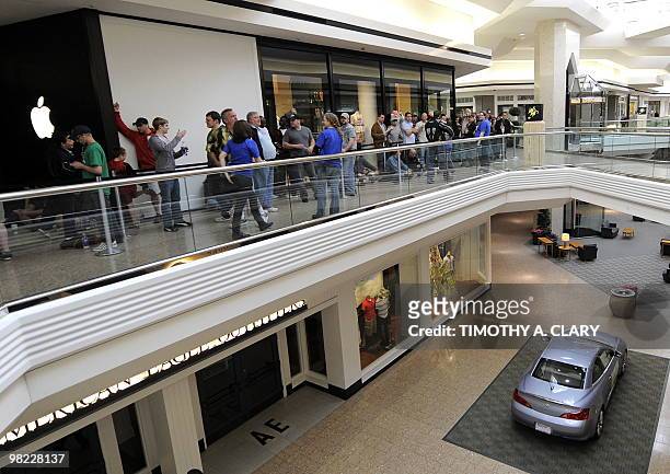 Customers wait in line to be one of the first to buy the iPad at the Apple Store at West Farms Mall in Farmington, Connecticut, on April 3, 2010....