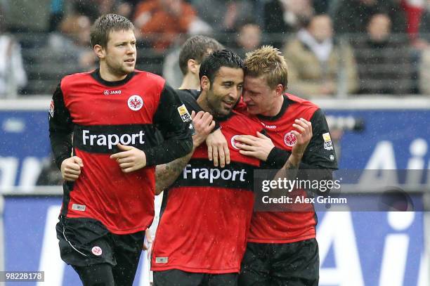 Selim Teber of Frankfurt celebrates his team's first goal with team mates Marco Russ and Patrick Ochs during the Bundesliga match between Eintracht...