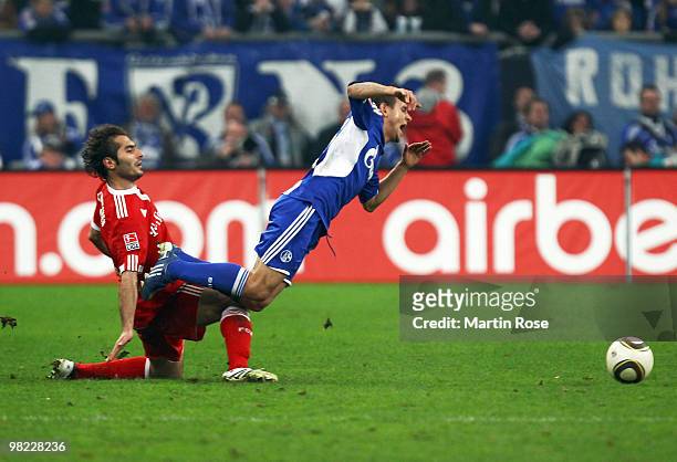 Rafinha of Schalke is fouled by Hamit Altintop of Muenchen during the Bundesliga match between FC Schalke 04 and FC Bayern Muenchen at the Veltins...