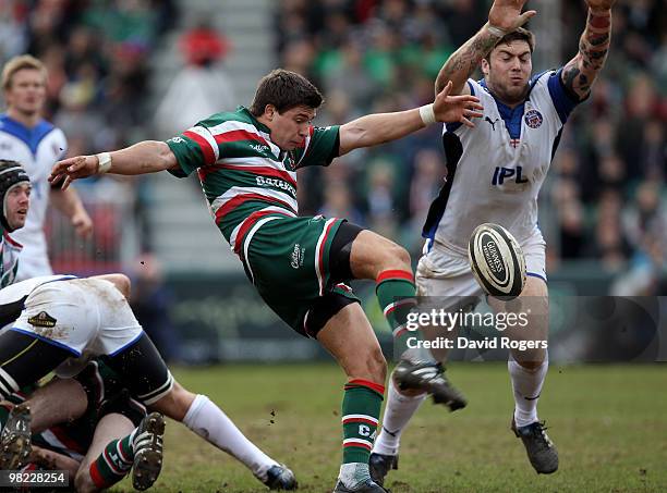 Ben Youngs of Leicester kicks the ball past Matt Banahan during the Guinness Premiership match between Leicester Tigers and Bath at Welford Road on...