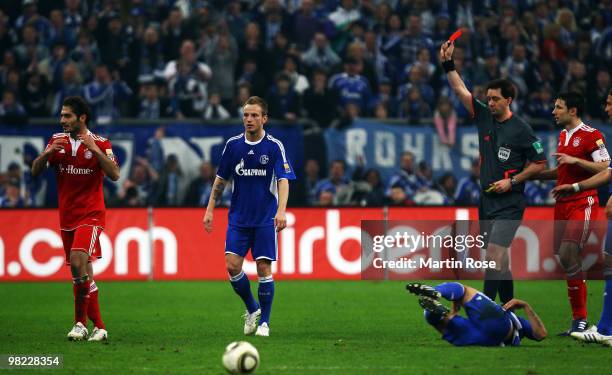 Referee Manuel Graefe shows Hamit Altintop of Muenchen the yellow red card during the Bundesliga match between FC Schalke 04 and FC Bayern Muenchen...