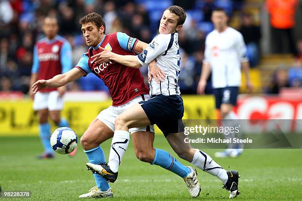 Stiliyan Petrov of Aston Villa holds off Jack Wilshere during the Bolton Wanderers and the Aston Villa Barclays Premier League match at The Reebok...