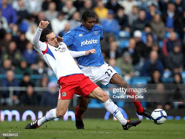 Kanu of Portsmouth gets tackled by Gael Givet of Blackburn Rovers during the Barclays Premier League match between Portsmouth and Blackburn Rovers at...