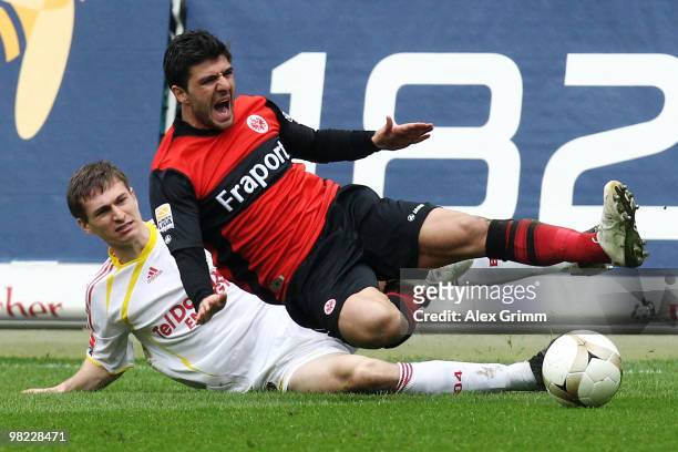 Daniel Schwaab of Leverkusen tackles Uemit Korkmaz of Frankfurt and is sent off afterwards during the Bundesliga match between Eintracht Frankfurt...