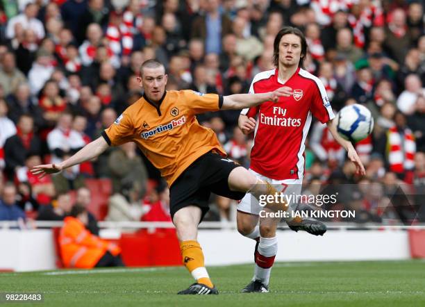 Wolverhampton Wanderers' English midfielder David Jones vies with Arsenal's Czech player Tomas Rosicky during the English Premier League football...