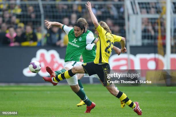 Claudio Pizarro of Bremen and Marcel Schmelzer of Dortmund fight for the ball during the Bundesliga match between Borussia Dortmund and SV Werder...