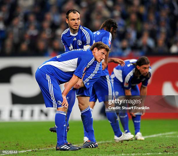 Benedikt Hoewedes and Heiko Westermann of Schalke look dejected during the Bundesliga match between FC Schalke 04 and FC Bayern Muenchen at the...