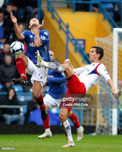 Michael Brown of Portsmouth competes with Morten Gamst Pederson of Blackburn Rovers during the Barclays Premier League match between Portsmouth and...