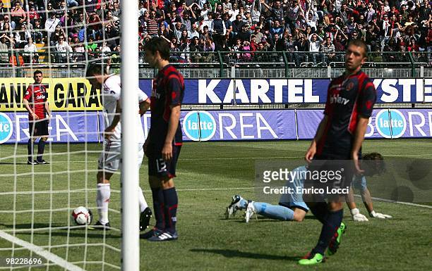 Davide Astori , Michele Canini and goalkeeper Federico Marchetti react after Davide Astori's own goal during the Serie A match between Cagliari...