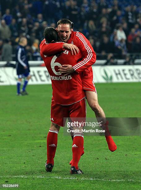 Franck Ribery of Muenchen celebrates with team mate Martin Demichelis after the Bundesliga match between FC Schalke 04 and FC Bayern Muenchen at the...