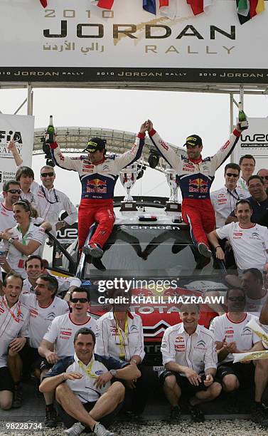 French driver Sebastien Loeb and his co-driver Daniel Elena celebrate on their Citroen C4 their victory in the Jordan Rally in Amman on April 3,...