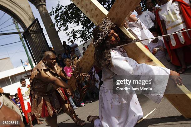 Faithfull take part in the reenactment of the Passion of Jesus Christ in the Iztapalapa district during Good Friday on April 2, 2010 east of Mexico...