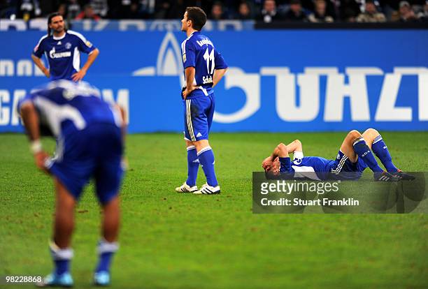 Heiko Westermann and Alexander Baumjohann of Schalke look dejected at the end of the Bundesliga match between FC Schalke 04 and FC Bayern Muenchen at...
