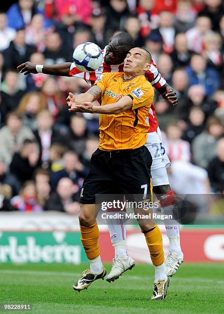 Craig Fagan of Hull battles Abdoulaye Faye of Stoke during the Barclays Premier League match between Stoke City and Hull City at the Britannia...