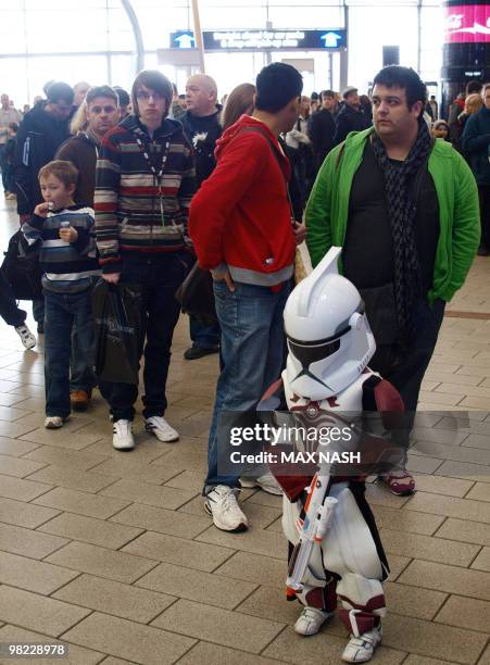 Jamie Mowles, 6 years old, wearing a 'Star Wars' uniform, waits in the line ahead of the Royal Philharmonic Concert Orchestra through the 'Star Wars...