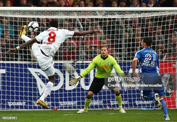 Mohamadou Idrissou of Freiburg with the ball against goalkeeper Philipp Heerwagen of Bochum during the Bundesliga match between SC Freiburg and VfL...