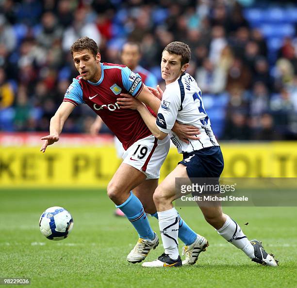 Stiliyan Petrov of Aston Villa holds off Jack Wilshere during the Bolton Wanderers and Aston Villa Barclays Premier League match at The Reebok...