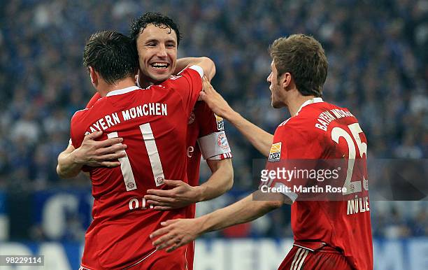 Mark van Bommel of Muenchen celebrates with team mate Ivica Olic their 2nd goal during the Bundesliga match between FC Schalke 04 and FC Bayern...