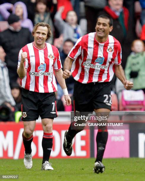 Sunderland's Dutch midfielder Bolo Zenden celebrates scoring their third goal with Paraguayan defender Paulo Da Silva during the English Premier...