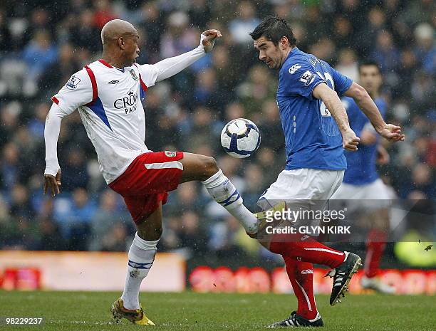 Blackburn's Senegalese striker El-Hadji Diouf vies with Portsmouth's Scottish midfielder Richard Hughes during the English Premier League football...