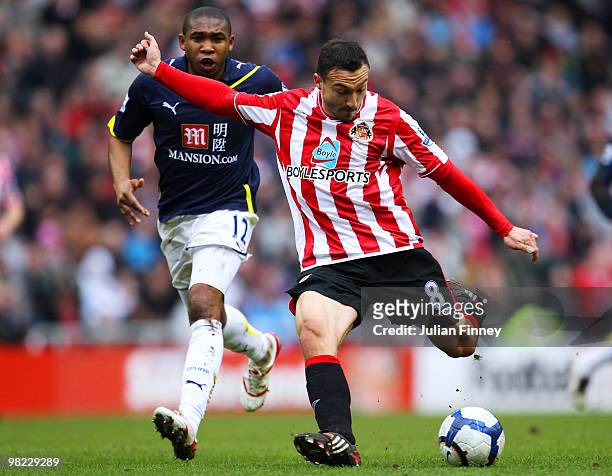 Steed Malbranque of Sunderland has a shot at goal as Wilson Palacios of Spurs watches during the Barclays Premier League match between Sunderland and...