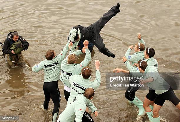 Cambridge Cox Ted Randolph is thrown into the River Thames by his crew after defeating Oxford during the 156th Oxford and Cambridge University Boat...