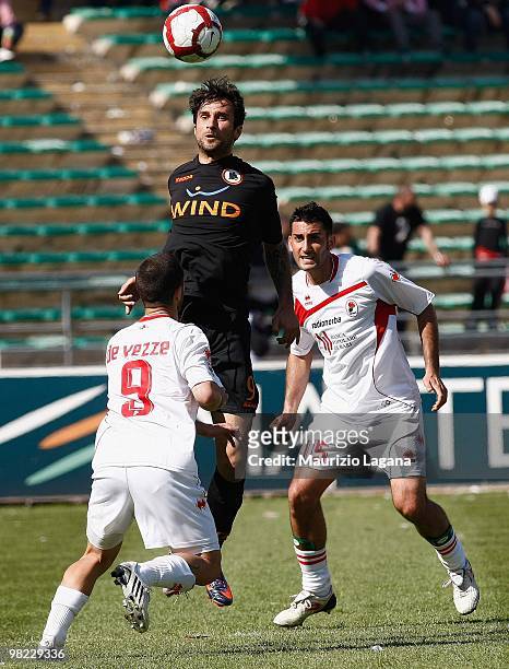 Daniel De Vezze and Nicola Belmonte of AS Bari compete for the ball with Mirko Vucinic of AS Roma during the Serie A match between AS Bari and AS...