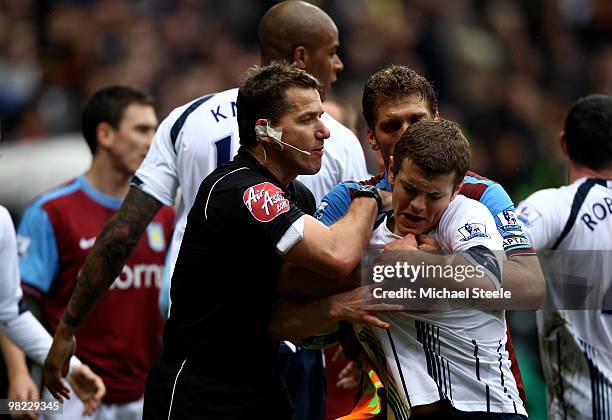 Jack Wilshere of Bolton is lead away from an end of match scuffle by assistant referee Halliday and Stiliyan Petrov of Aston Villa during the Bolton...