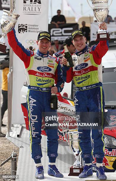 Second-placed winners of the FIA world championship in Jordan, Jari-Matti Latvala of Finland and co-driver Miikka Anttila pose for a picture with...