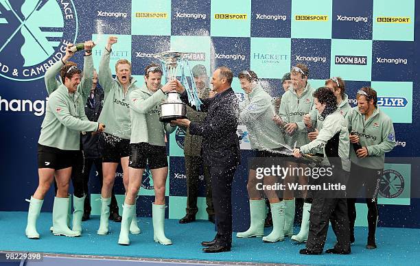 Deaglan McEachern, President of Cambridge is presented the trophy by Sir Steve Redgrave after the 156th Oxford and Cambridge University Boat Race on...