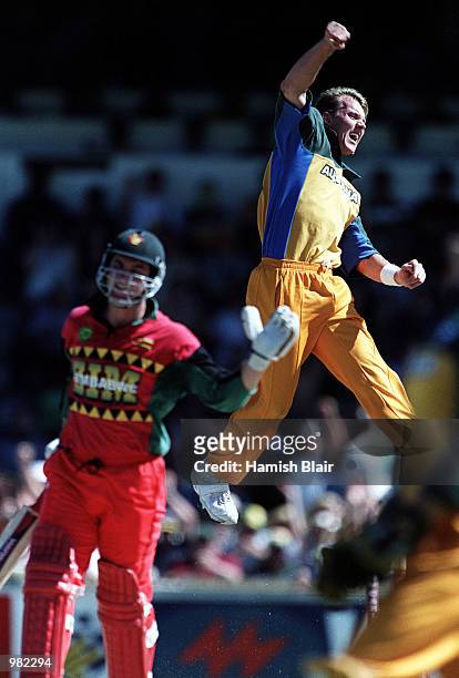 Brett Lee of Australia celebrates the wicket of Alistair Campbell of Zimbabwe caught by Adam Gilchrist for 27 during the Carlton Series One Day...