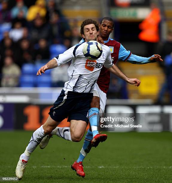 Sam Ricketts of Bolton feels the challenge of Ashley Young during the Bolton Wanderers and Aston Villa Barclays Premier League match at The Reebok...