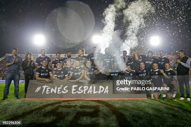 Scottish players pose for pictures after defeating Argentina by 44-15 during their international test match, at the Centenario stadium, in...