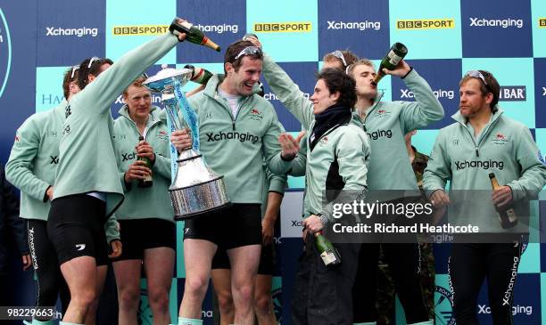 Deaglan McEachern, President of Cambridge holds the trophy as he talks to cox Ted Randolph after the 156th Oxford and Cambridge University Boat Race...