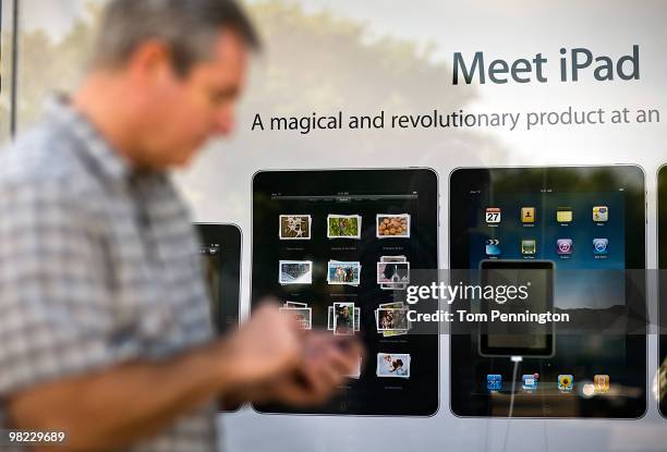 Customers wait in line outside the Apple Store to purchase the new iPad April 3, 2010 in Fort Worth, Texas. Debuting today, the much heralded iPad...