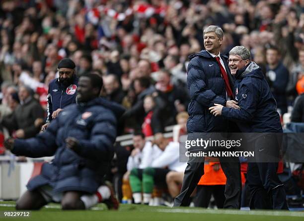 Arsenal's French manager Arsene Wenger celebrates Nicklas Bendtner's late goal with assistant manager Pat Rice during the English Premier League...