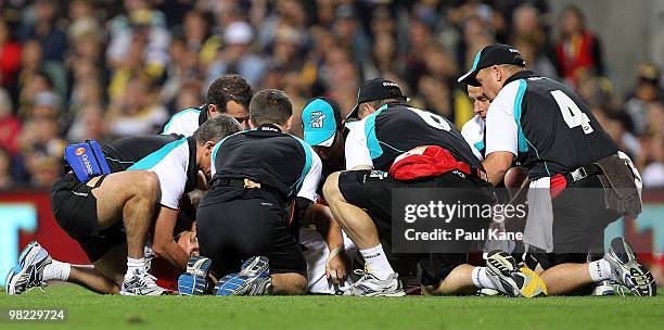 Trainers attend to Jacob Surjan of the Power during the round two AFL match between the West Coast Eagles and Port Adelaide Power at Subiaco Oval on...