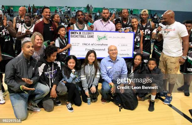 Celebrity players help present a donation to the Boys & Girls Club of America at the Celebrity Basketball Game Sponsored By Sprite during the 2018...