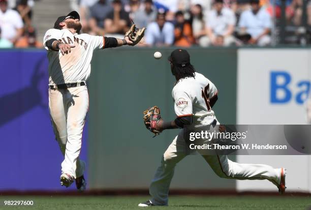 The ball falls just out of the reach of Brandon Crawford of the San Francisco Giants for a double off the bat of Manuel Margot of the San Diego...
