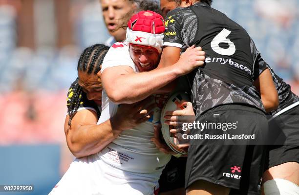 Martin Taupau and Te Maire Martin of New Zealand tackle Chris Hill of England during the second half of a Rugby League Test Match between England and...