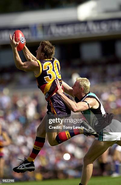 Peter Vardy for Adelaide marks ahead of Stephen Paxman for Port in the match between the Adelaide Crows and Port Power in round 3 of the AFL played...