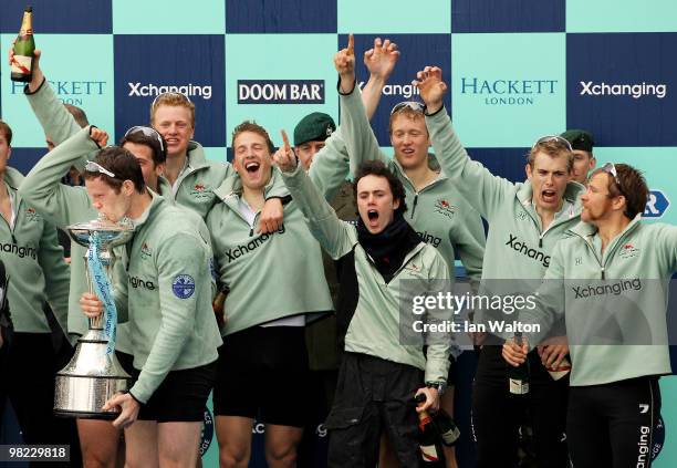 Deaglan McEachern, President of Cambridge kisses the trophy as team mates celebrate victory after the 156th Oxford and Cambridge University Boat Race...