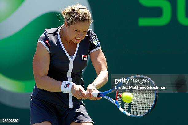 Kim Clijsters of Belgium returns a shot against Venus Williams of the United States during the women's final of the 2010 Sony Ericsson Open at...