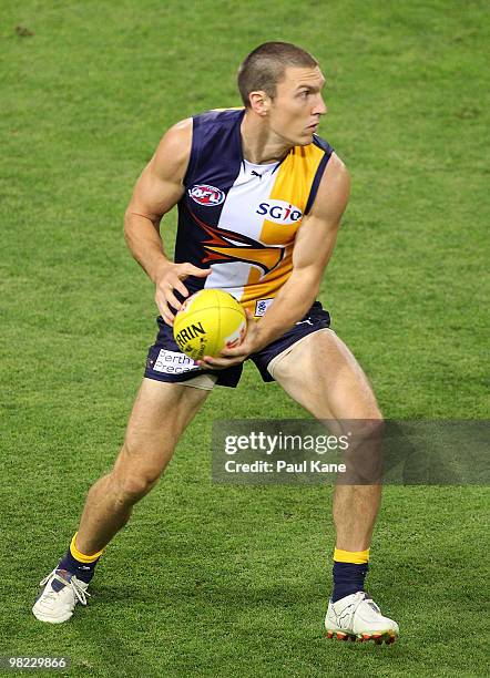 Eric Mackenzie of the Eagles looks to dispose of the ball during the round two AFL match between the West Coast Eagles and Port Adelaide Power at...