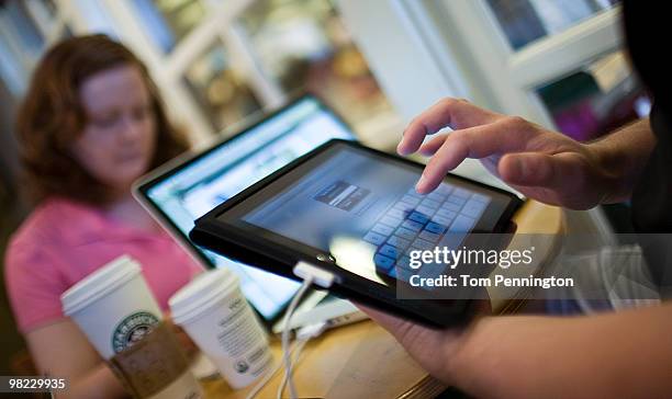 Jamie Phelps syncs his newly purchased iPad while visiting a Starbucks Coffee with his wife, Ann Phelps, April 3, 2010 in Fort Worth, Texas. Debuting...