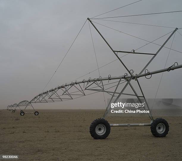 Large-scale irrigation machinery is parked at a half-desertificated farmland on April 3, 2010 in Xinghe County of Ulanqab, Inner Mongolia Autonomous...