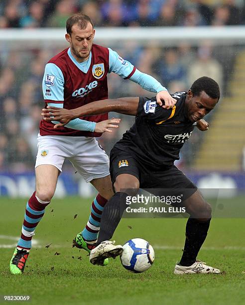 Burnley's Scottish forward Steven Fletcher vies with Manchester City's English defender Nedum Onuoha during the English Premier League football match...